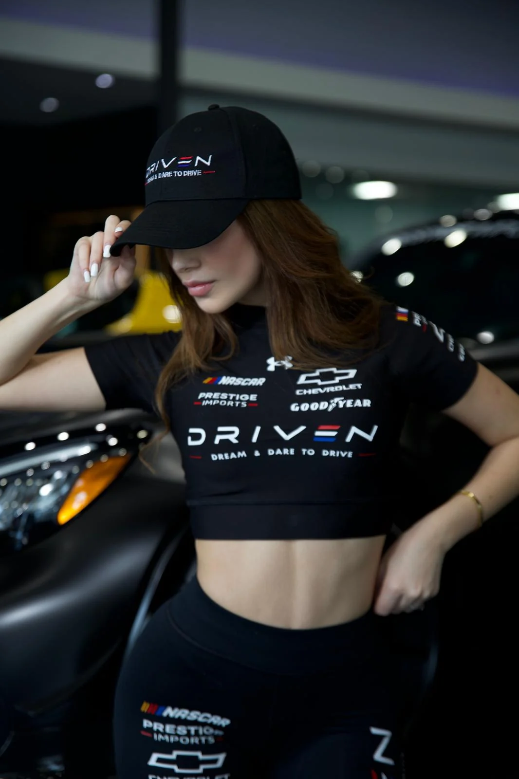 Mila wearing her black DRIVEN cap and uniform